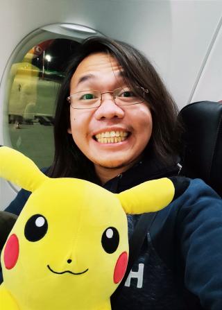 Selfie - Wearing Eyeglasses and Black Jacket; Holding Pikachu Stuffed Toy